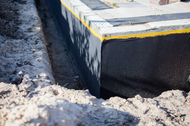 Professional Basement Waterproofing technician working in Lawrence, KS